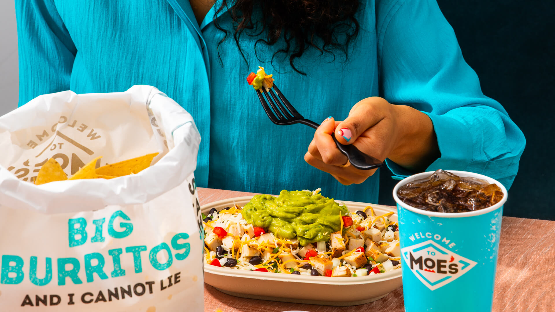 Moe's bowl with chips and drink for lunch